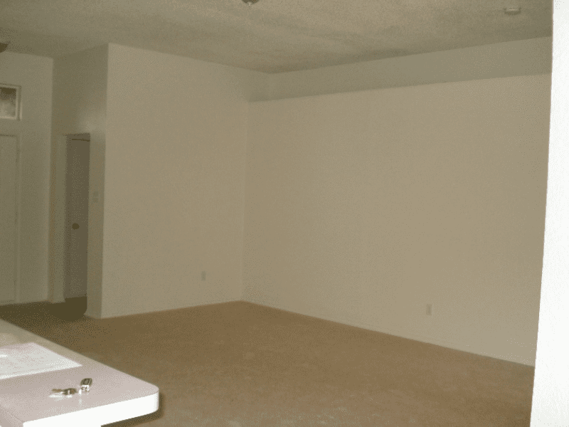 Empty room with beige carpet and white walls.